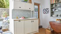 The beautiful cottage style kitchen opens up to the outside space.