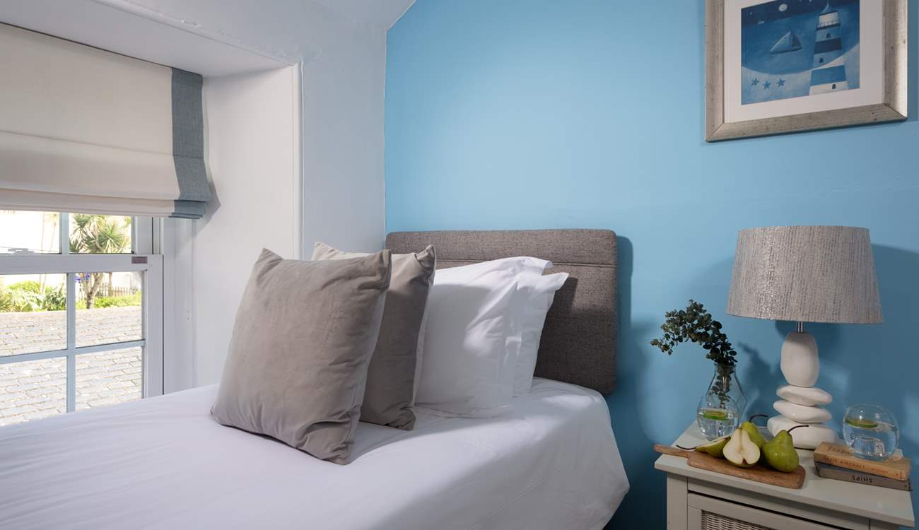 Pretty pastel shades await in the twin bedroom. 