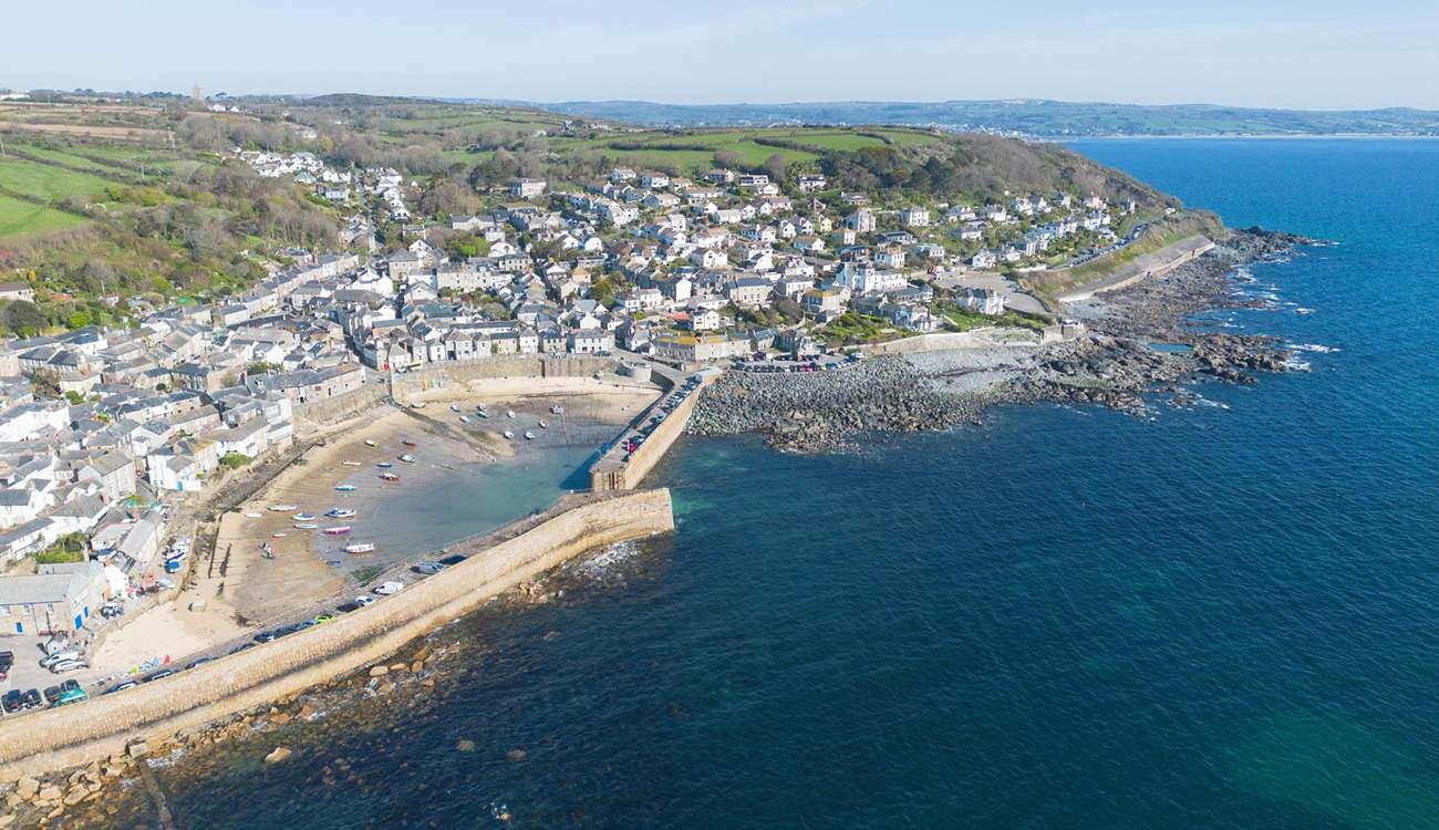 An aerial view of the pretty village of Mousehole, Coastguard Cottage is just a minutes walk from the beach.
