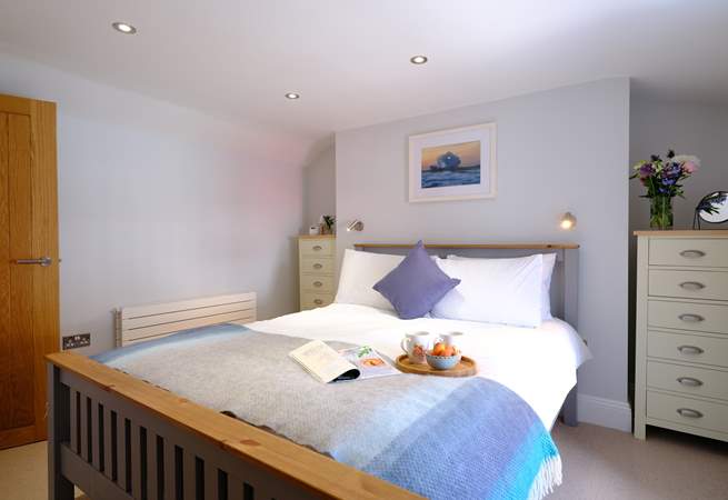 Bedroom 1, decorated in relaxing pastels is light and airy.