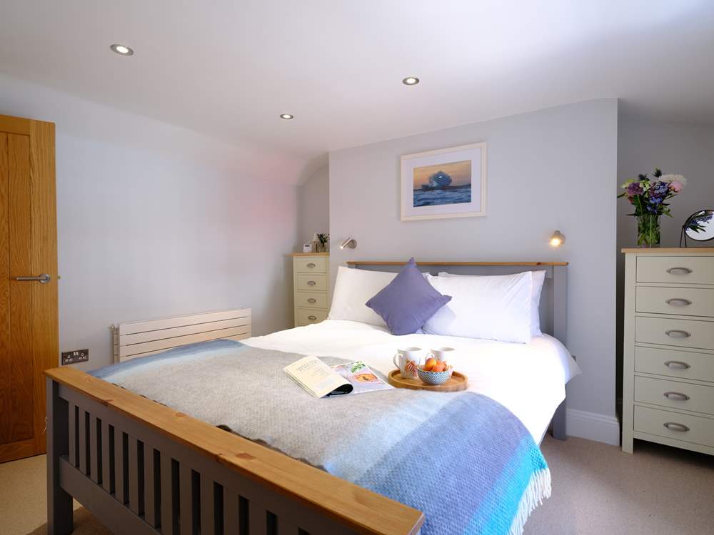 Bedroom 1, decorated in relaxing pastels is light and airy.