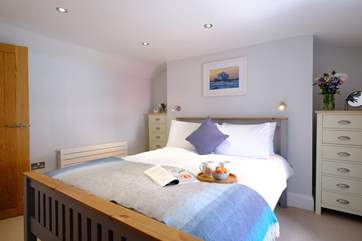 Bedroom 1, decorated in relaxing pastels is light and airy.