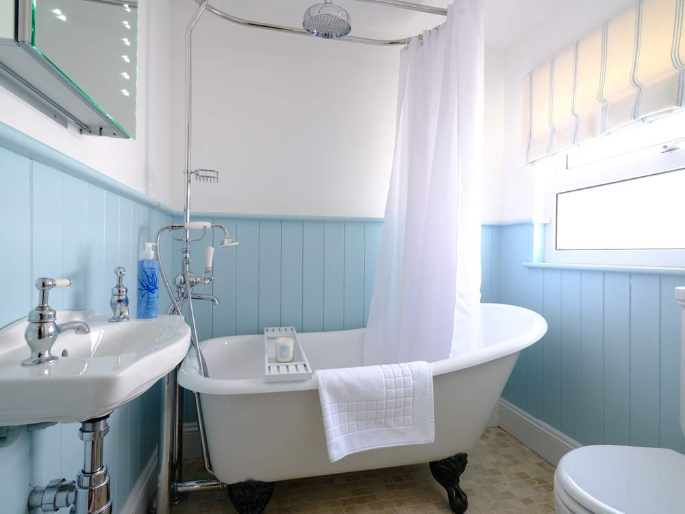 The family bathroom with super roll-top bath, perfect for a soak after a day at the beach.