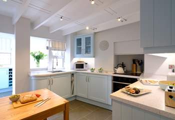 The kitchen is presented in stylish pastel tones.