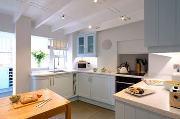 The kitchen is presented in stylish pastel tones.