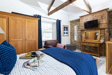 The king-size bed on the top floor is beautifully furnished and so inviting.