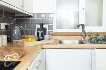 The fully equipped kitchen is a delightful space to conjure up a culinary delight.