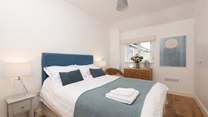 Bedroom 3 is beautifully styled with a king-size bed.