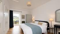 Calming colours in the main bedroom featuring a sumptuous super-king bed ensures relaxation and there is even a door out to the patio - a perfect spot for morning coffee.