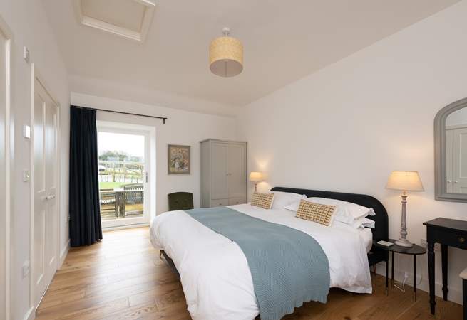 Calming colours in the main bedroom ensure relaxation and there is even a door out to the patio - a perfect spot for morning coffee.