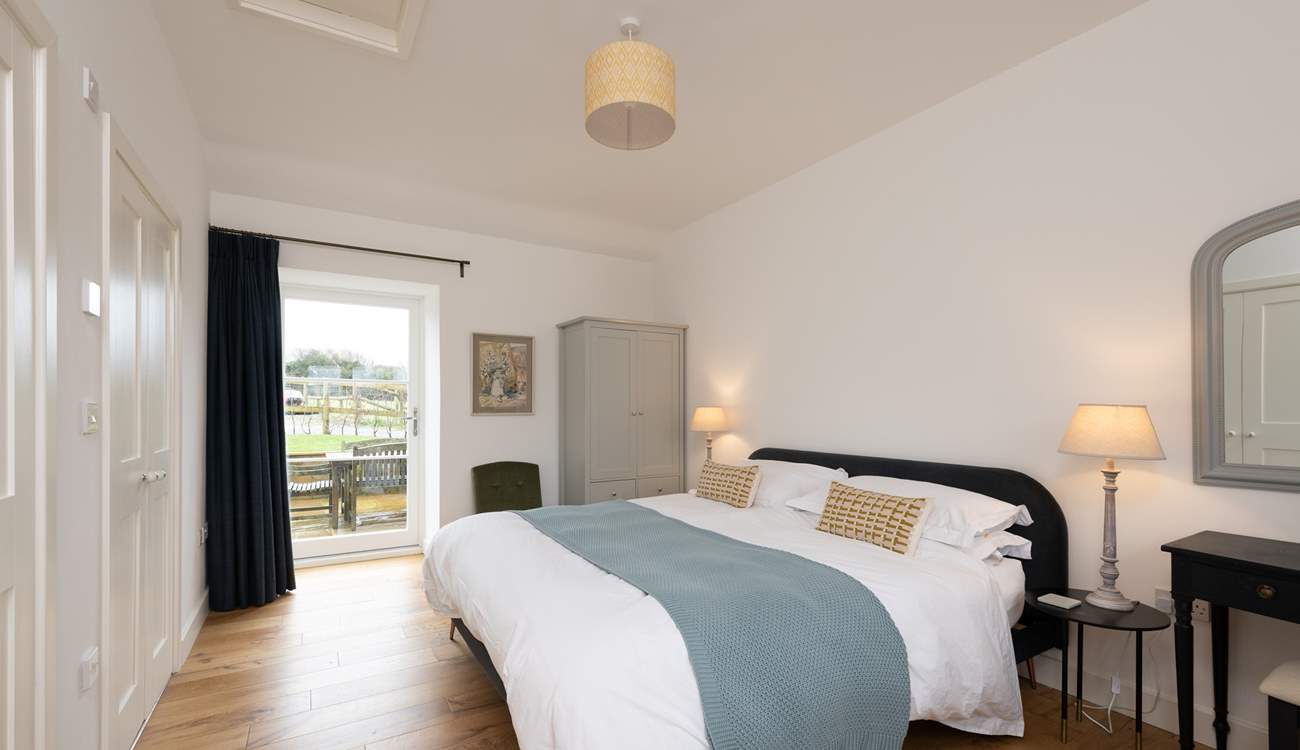 Calming colours in the main bedroom ensure relaxation and there is even a door out to the patio - a perfect spot for morning coffee.