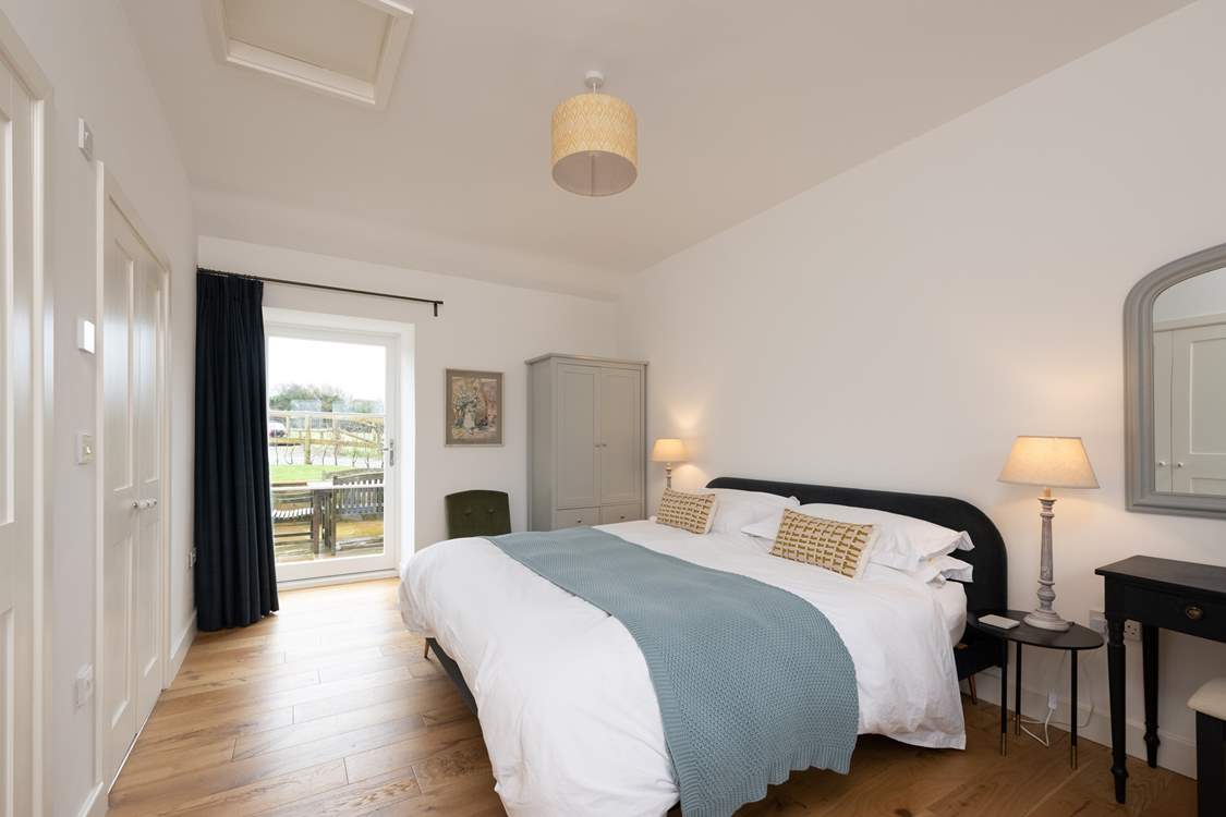 Calming colours in the main bedroom ensure relaxation and there is even a door out to the patio - a perfect spot for morning coffee.