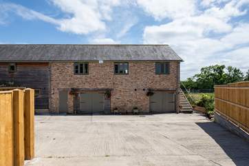 Enter the courtyard and park up directly outside The Mews. The property is accessed via a flight of steps to the right-hand side of the building.