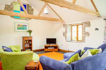 The beautiful rustic beams and stone walls make for a cosy living area.