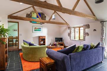 The beautiful rustic beams and stone walls make for a cosy living area.