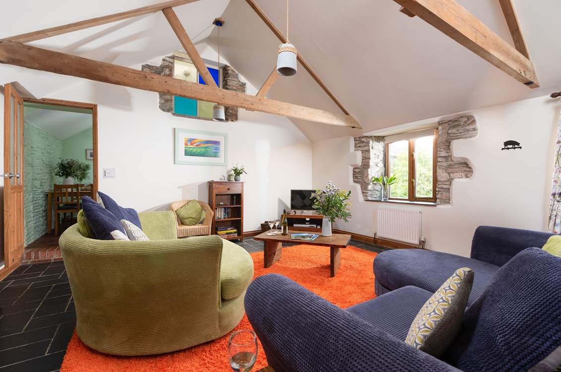 The beautiful rustic beams and stone walls make for a cosy living area.