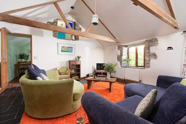 The beautiful rustic beams and stone walls make for a cosy living area.