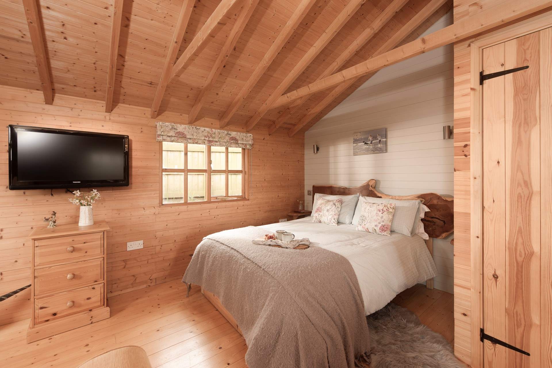 This bespoke hand-carved headboard makes a beautiful feature.