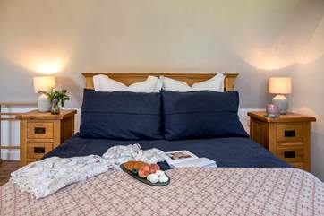 A gorgeously welcoming king-size bed awaits.