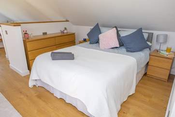 The two bedroom areas are separated by a half stairwell.