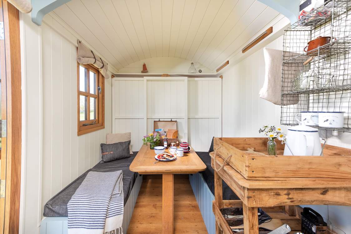 Enjoy scrumptious meals around the rustic dining-table and when you are ready for a good night's sleep, the double bed easily folds down from the wall to sit atop the table.