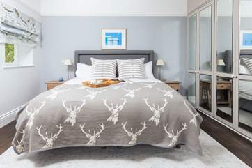 The main bedroom has a super-king sized bed and all the storage space you could possibly need on holiday here.