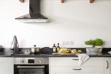 The kitchen has oodles of cupboards and work space.