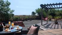 Gaze across the fields from this idyllic sunny spot. Relax in the hammocks with your favourite book.