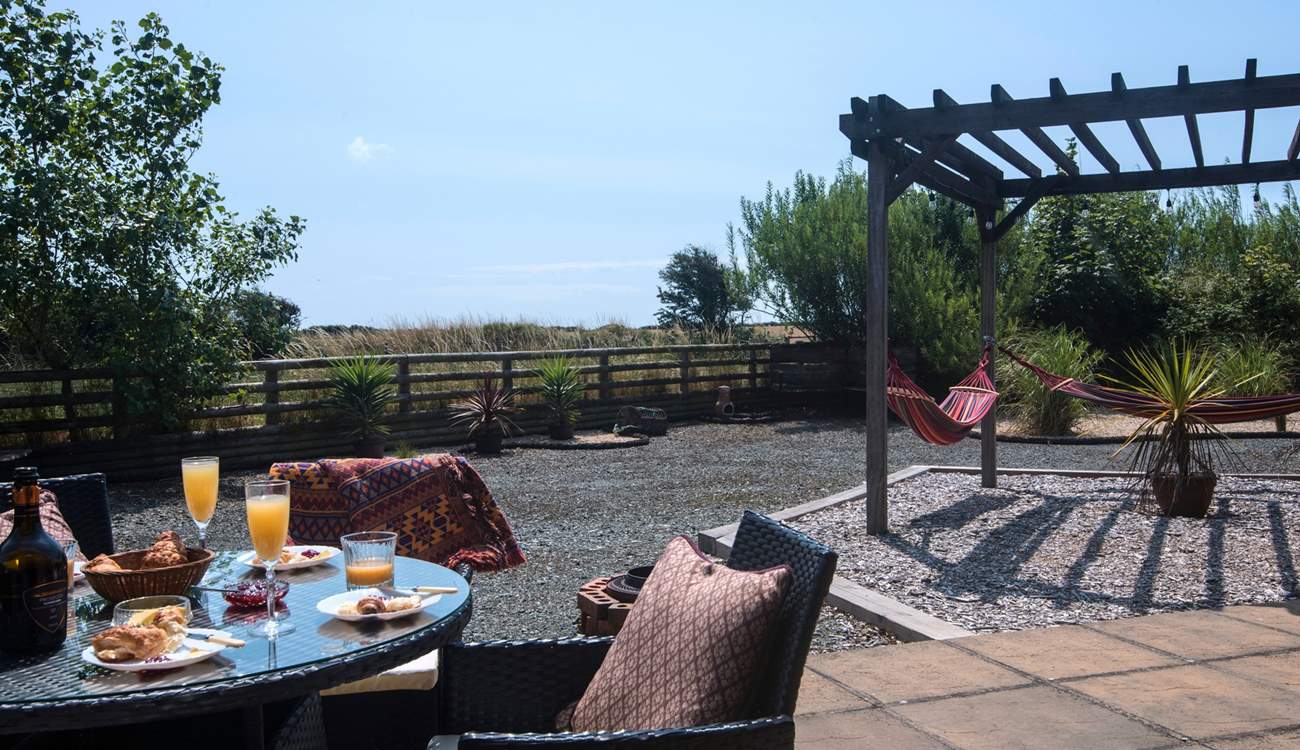 Gaze across the fields from this idyllic sunny spot. Relax in the hammocks with your favourite book.