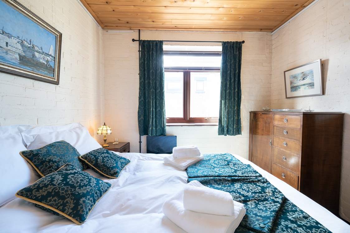 Fluffy white towels and crisp white linen in this charming 1940s bedroom.
