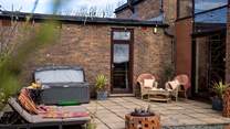 Hop in the hot tub and relax on the sun loungers.