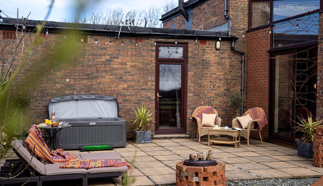 Hop in the hot tub and relax on the sun loungers.