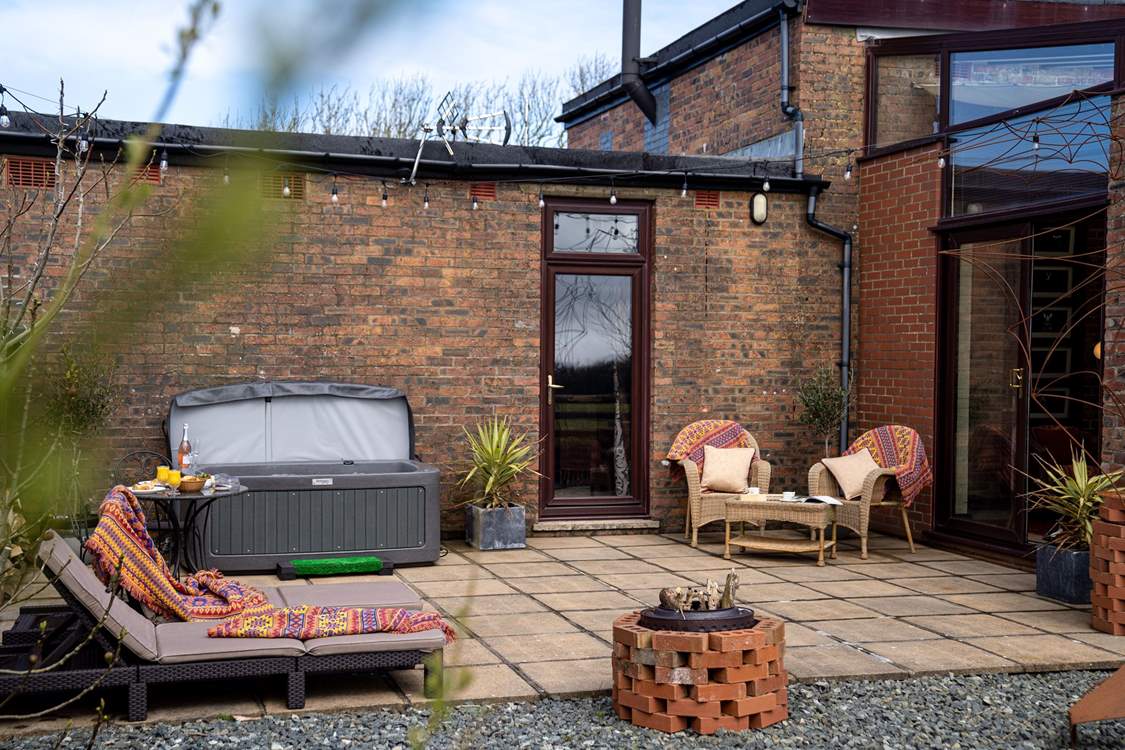 Hop in the hot tub and relax on the sun loungers.