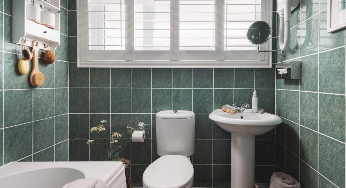 The family bathroom with a bath and a fitted shower to set you up for the day.