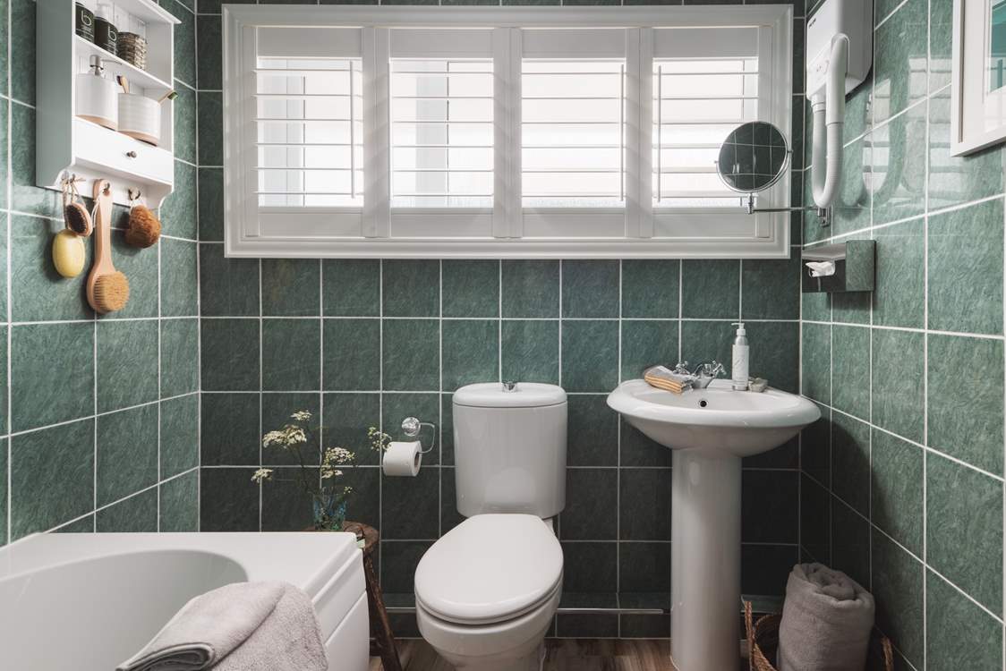 The family bathroom with a bath and a fitted shower to set you up for the day.