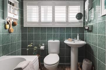 The family bathroom with a bath and a fitted shower to set you up for the day.