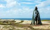 King Arthur's statue stands majestically on the cliff in Tintagel. - Thumbnail Image