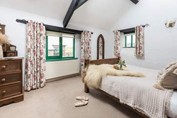 The characterful double bedroom with double height ceilings and exposed beams.