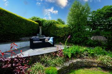 The terraced seating area gives you a bird's eye view of the pretty garden.