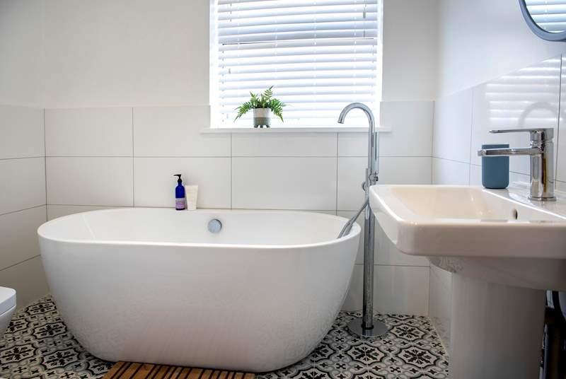 A gorgeous free-standing bath awaits you in the family bathroom.