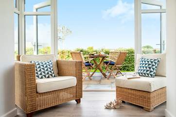 Double doors lead out from the sitting-area to the garden which has a choice of two places to eat out.