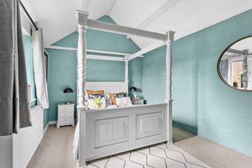 The pretty bedroom at Chappell Cottage has a dreamy four-poster bed.