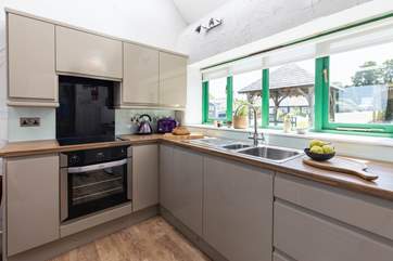 The sleek newly fitted kitchen looks out over the pretty courtyard.
