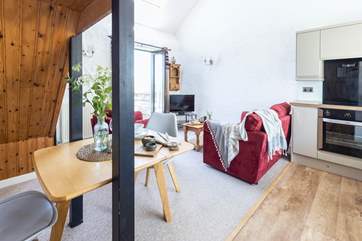 The delightful living area has access to the patio.
