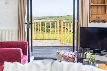 The deck leads out from the patio doors in the sitting-area.