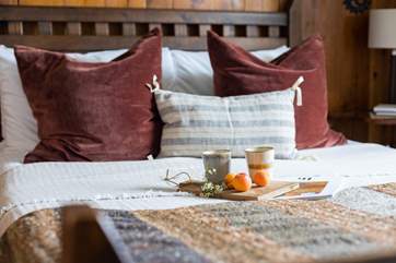 The double bedroom has a fabulous crafted bed and countryside views.