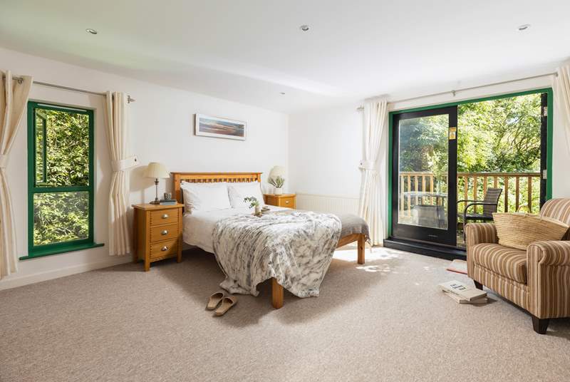 Breathe and relax in the gorgeous dual-aspect bedroom, surrounded by woodland foliage.