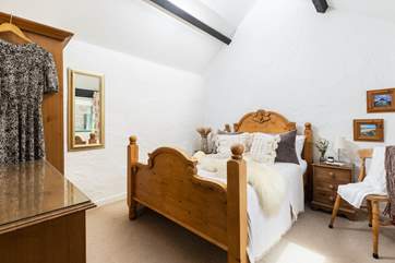 The double bedroom has a beautifully crafted bed.
