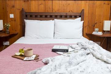Beautiful bed linens and feature furniture invite you to relax.