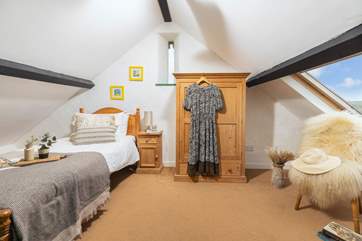The characterful single bedroom has a Velux window with fabulous countryside views.